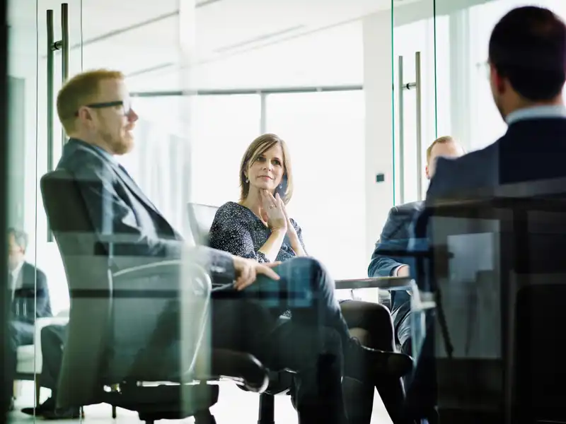 Executives sitting in a modern office having a meeting.